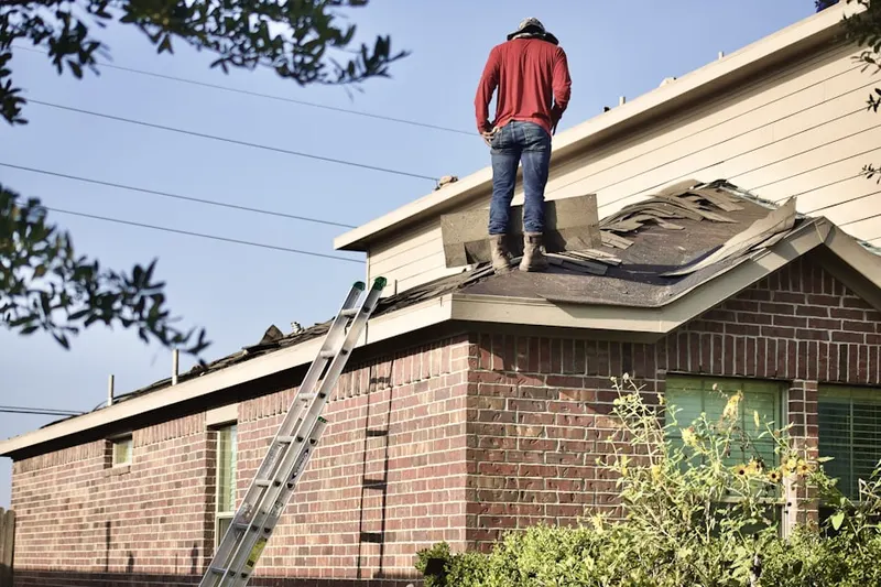Professional roofer working on a residential roof in Muscatine